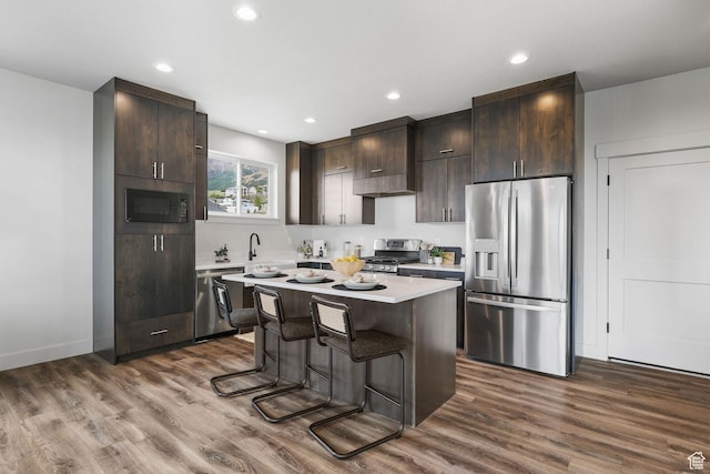 3071 N Mountain Rd Unit 4, North Ogden, UT 84414 - kitchen with appliances with stainless steel finishes, light countertops, dark brown cabinetry, dark wood-style flooring, and recessed lighting