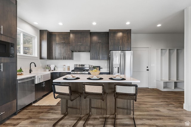 3071 N Mountain Rd Unit 4, North Ogden, UT 84414 - kitchen featuring stainless steel appliances, a kitchen island, light countertops, dark brown cabinets, and recessed lighting