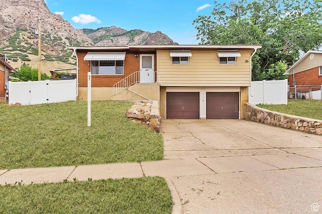 446 Robins Ave, Ogden, UT 84404 - ranch-style home with a mountain view, a garage, and driveway