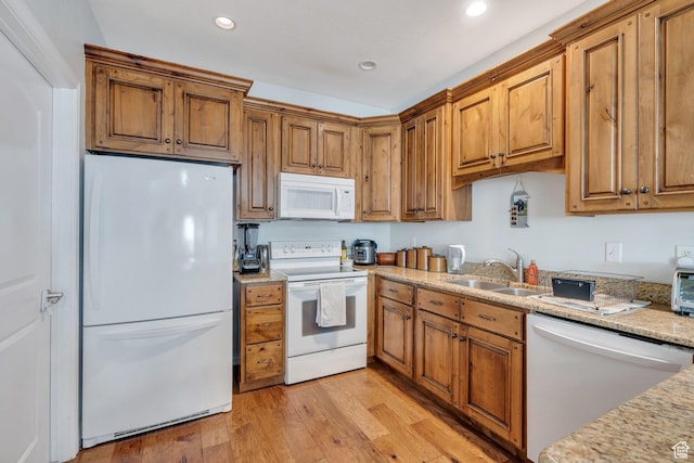 588 S 350 E, Pleasant Grove, UT 84062 - kitchen with white appliances, brown cabinets, light wood-style floors, recessed lighting, and light stone counters