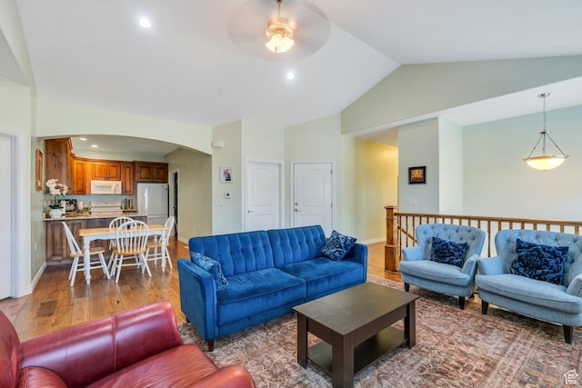 588 S 350 E, Pleasant Grove, UT 84062 - living area featuring ceiling fan, arched walkways, wood finished floors, recessed lighting, and high vaulted ceiling