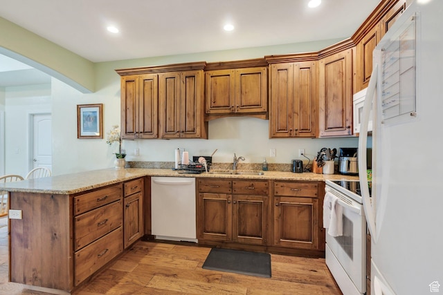 588 S 350 E, Pleasant Grove, UT 84062 - kitchen featuring white appliances, a peninsula, arched walkways, recessed lighting, and light wood-type flooring