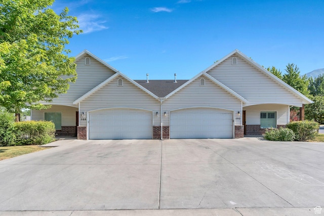 588 S 350 E, Pleasant Grove, UT 84062 - view of property featuring driveway, an attached garage, and brick siding