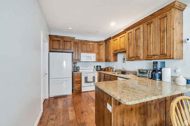 588 S 350 E, Pleasant Grove, UT 84062 - kitchen featuring white appliances, a peninsula, brown cabinets, dark wood finished floors, and recessed lighting