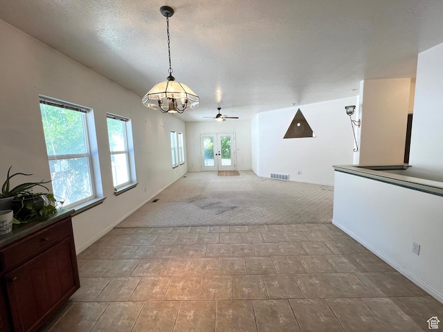 560 E 700 N, Logan, UT 84321 - unfurnished dining area with a ceiling fan, light colored carpet, and a chandelier