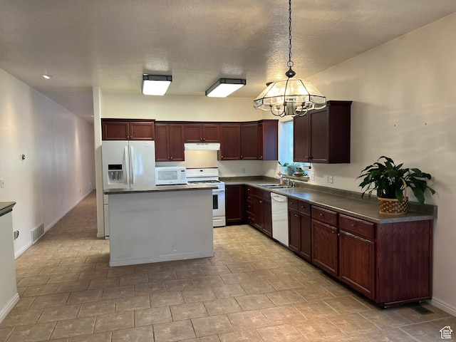 560 E 700 N, Logan, UT 84321 - kitchen featuring white appliances, dark countertops, a chandelier, under cabinet range hood, and pendant lighting