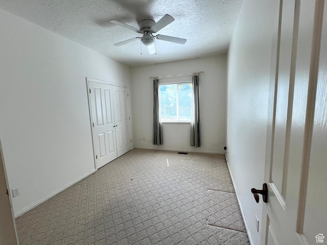 560 E 700 N, Logan, UT 84321 - unfurnished bedroom featuring a textured ceiling, ceiling fan, and a closet