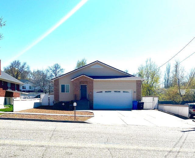 560 E 700 N, Logan, UT 84321 - ranch-style house featuring brick siding, concrete driveway, an attached garage, and a gate