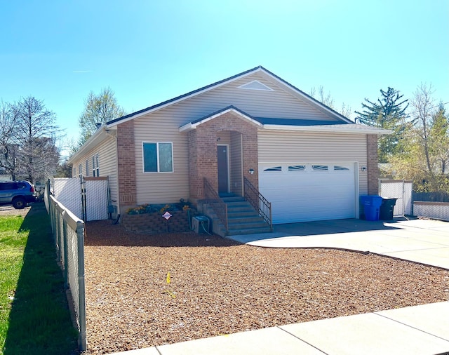560 E 700 N, Logan, UT 84321 - ranch-style house with concrete driveway, brick siding, and a garage
