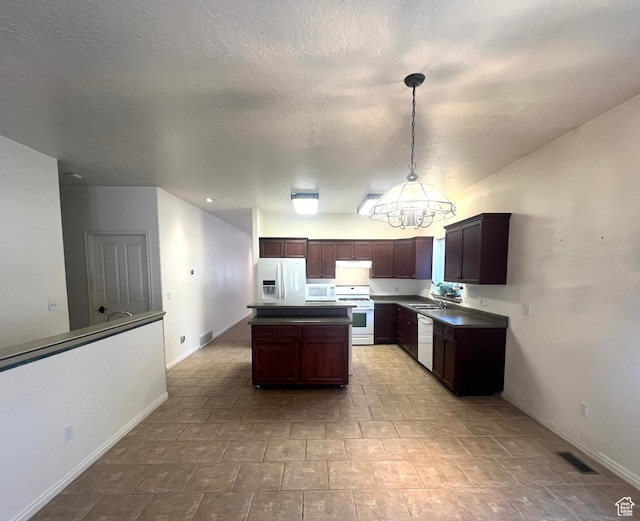 560 E 700 N, Logan, UT 84321 - kitchen with white appliances, a kitchen island, hanging light fixtures, a chandelier, and dark brown cabinets