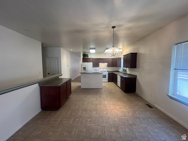 560 E 700 N, Logan, UT 84321 - kitchen featuring white appliances, a center island, hanging light fixtures, a chandelier, and under cabinet range hood