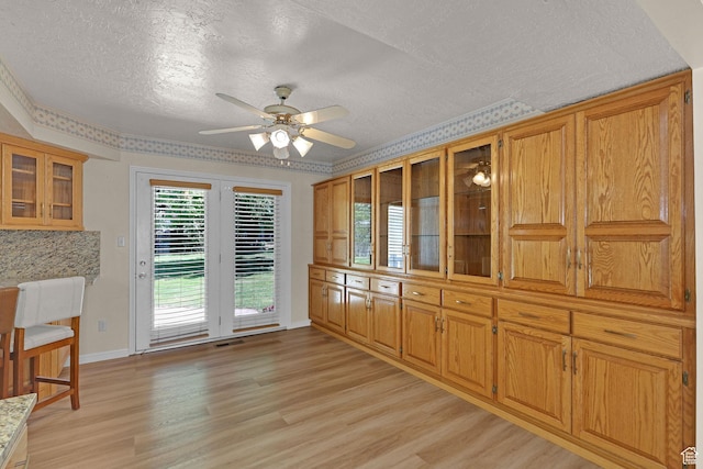 192 N Highland Blvd, Brigham City, UT 84302 - unfurnished dining area featuring a textured ceiling, light wood finished floors, and a ceiling fan