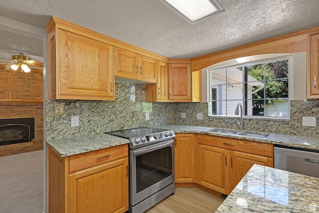 192 N Highland Blvd, Brigham City, UT 84302 - kitchen with stainless steel appliances, a ceiling fan, light stone countertops, a textured ceiling, and decorative backsplash