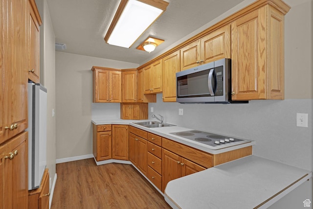 192 N Highland Blvd, Brigham City, UT 84302 - kitchen featuring stainless steel microwave, electric stovetop, light wood finished floors, light countertops, and freestanding refrigerator