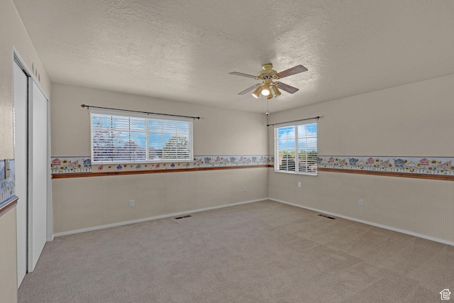 192 N Highland Blvd, Brigham City, UT 84302 - spare room with ceiling fan, wainscoting, light carpet, and a textured ceiling