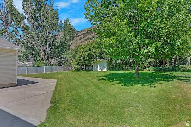 192 N Highland Blvd, Brigham City, UT 84302 - view of yard with an outdoor structure, a patio area, and a mountain view