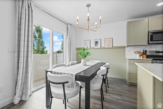 356 N Starboard Ln Unit 1555, Saratoga Springs, UT 84045 - dining room featuring a chandelier, a wainscoted wall, and light wood-style flooring