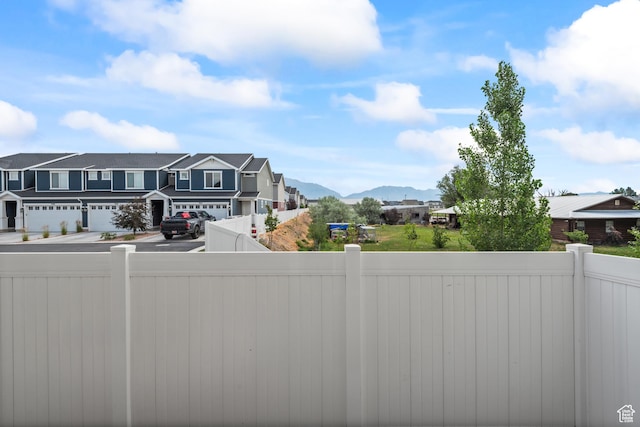 356 N Starboard Ln Unit 1555, Saratoga Springs, UT 84045 - view of yard with driveway, a residential view, a mountain view, and a garage
