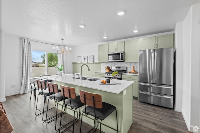 356 N Starboard Ln Unit 1555, Saratoga Springs, UT 84045 - kitchen with appliances with stainless steel finishes, green cabinetry, a chandelier, dark wood-type flooring, and recessed lighting