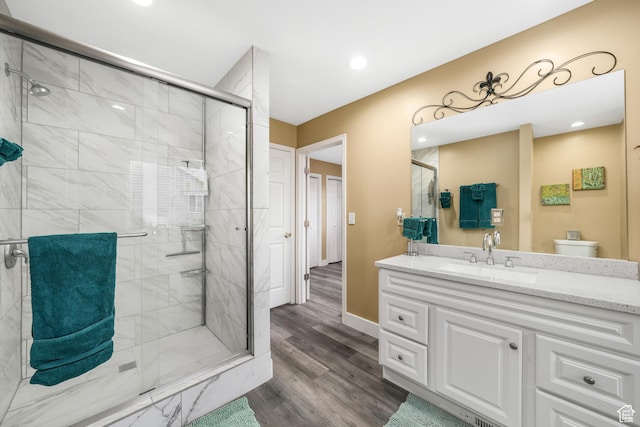 3561 S Jenelles Bay, West Valley City, UT 84119 - bathroom featuring a stall shower, vanity, wood finished floors, and recessed lighting