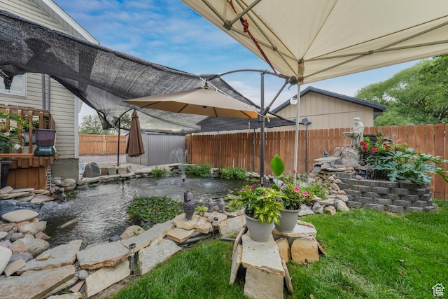 3561 S Jenelles Bay, West Valley City, UT 84119 - fenced backyard featuring a garden pond