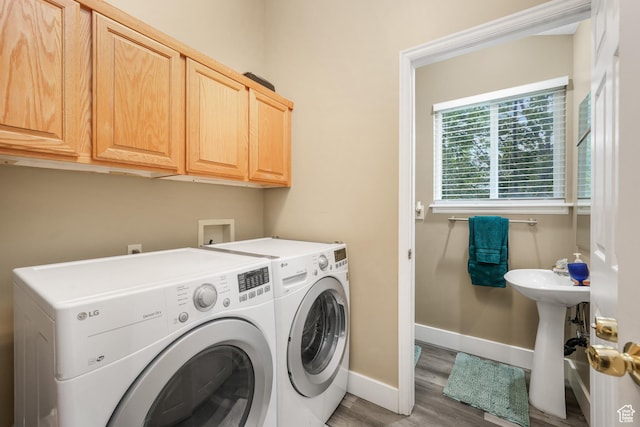 3561 S Jenelles Bay, West Valley City, UT 84119 - laundry area with separate washer and dryer, wood finished floors, and cabinet space