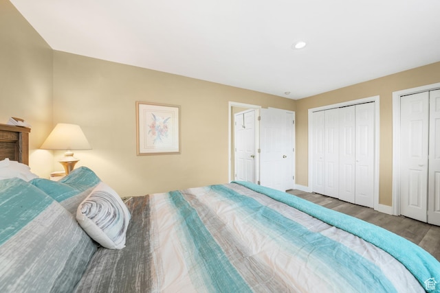 3561 S Jenelles Bay, West Valley City, UT 84119 - bedroom featuring wood finished floors, two closets, and recessed lighting