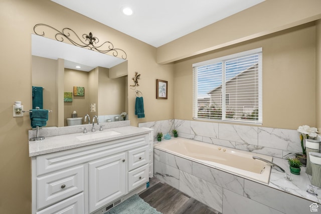 3561 S Jenelles Bay, West Valley City, UT 84119 - full bath featuring a garden tub, vanity, and wood finished floors
