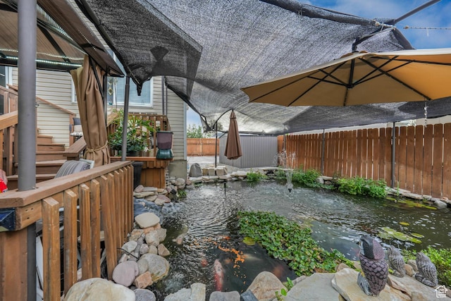 3561 S Jenelles Bay, West Valley City, UT 84119 - fenced backyard featuring a small pond and stairs