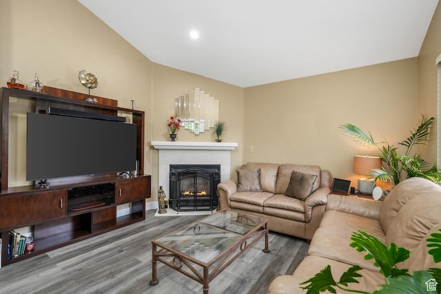 3561 S Jenelles Bay, West Valley City, UT 84119 - living room with a fireplace with flush hearth, wood finished floors, lofted ceiling, and recessed lighting