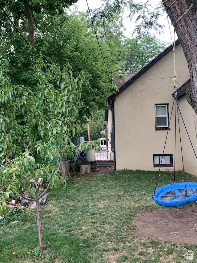 2425 Van Buren Ave, Ogden, UT 84401 - view of grassy yard with a trampoline