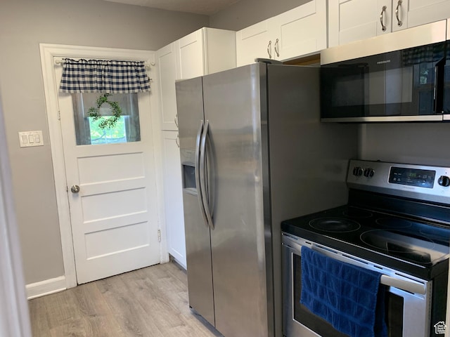 2425 Van Buren Ave, Ogden, UT 84401 - kitchen featuring appliances with stainless steel finishes, light wood-style flooring, and white cabinetry