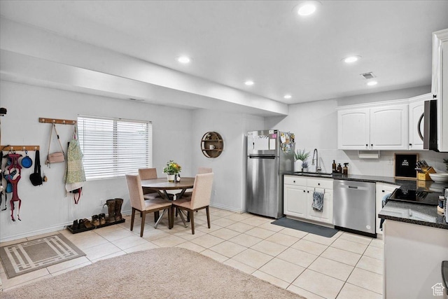 656 W 1310 N, Lehi, UT 84043 - kitchen featuring stainless steel appliances, white cabinetry, recessed lighting, light tile patterned floors, and decorative backsplash