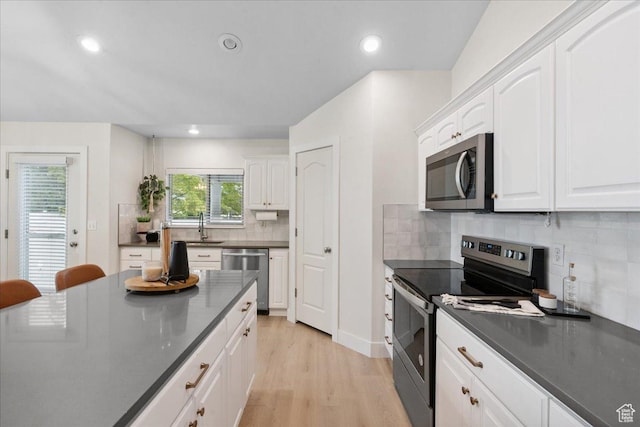 656 W 1310 N, Lehi, UT 84043 - kitchen featuring stainless steel appliances, dark countertops, white cabinets, light wood-style flooring, and recessed lighting