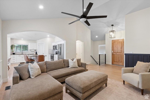 656 W 1310 N, Lehi, UT 84043 - living area featuring arched walkways, light wood finished floors, ceiling fan, recessed lighting, and high vaulted ceiling