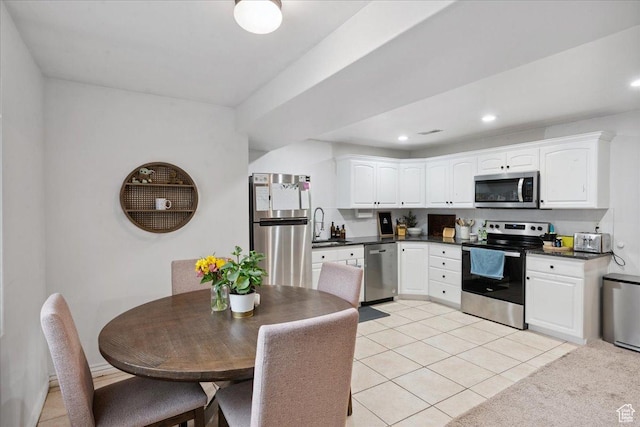 656 W 1310 N, Lehi, UT 84043 - kitchen featuring stainless steel appliances, dark countertops, white cabinets, light tile patterned floors, and recessed lighting
