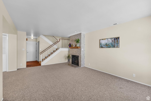 607 E 4030 S, Murray, UT 84107 - unfurnished living room featuring carpet floors, stairs, and a large fireplace