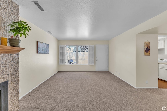 607 E 4030 S, Murray, UT 84107 - unfurnished living room with carpet flooring, a fireplace, and a textured ceiling