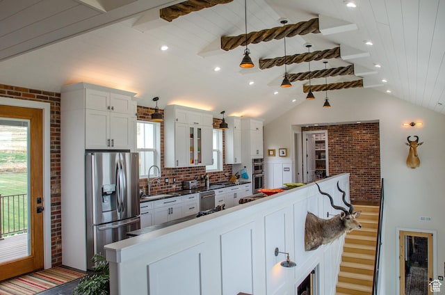 5958 W Sunridge View Ln, Payson, UT 84651 - kitchen featuring stainless steel appliances, white cabinets, wood ceiling, brick wall, and dark countertops