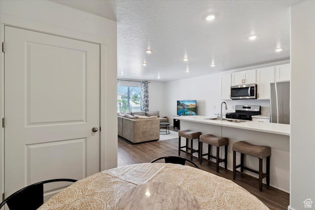 1826 N Blue Iris Ave, Tooele, UT 84074 - dining room with dark wood-style flooring and recessed lighting