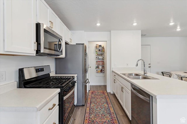 1826 N Blue Iris Ave, Tooele, UT 84074 - kitchen with stainless steel appliances, wood finished floors, a peninsula, light countertops, and white cabinetry