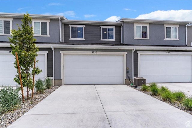 1826 N Blue Iris Ave, Tooele, UT 84074 - multi unit property featuring a garage, stucco siding, and driveway