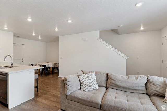 1826 N Blue Iris Ave, Tooele, UT 84074 - living room featuring recessed lighting, wood finished floors, and stairs