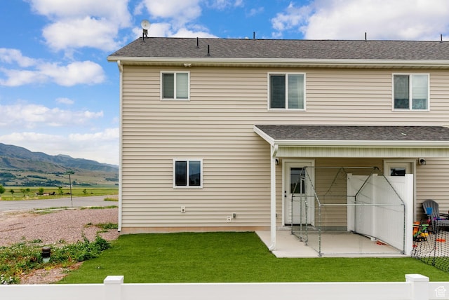 87 E Legacy Dr, Franklin, ID 83237 - back of property featuring a patio, a mountain view, and a lawn