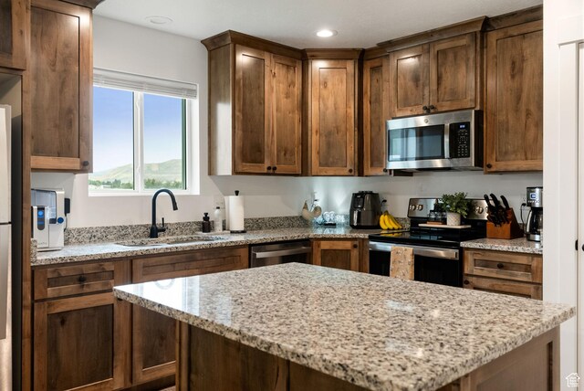 87 E Legacy Dr, Franklin, ID 83237 - kitchen with stainless steel appliances, light stone countertops, a kitchen island, and recessed lighting
