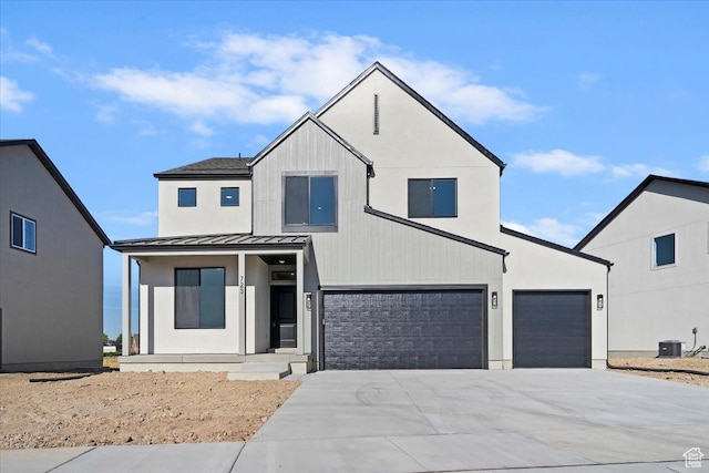 723 N Plainsman Dr Unit 109, Spanish Fork, UT 84660 - view of front of home featuring a standing seam roof, concrete driveway, covered porch, a garage, and a metal roof
