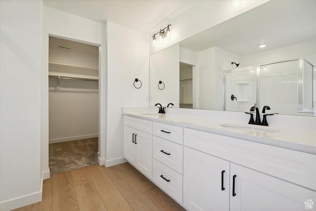 723 N Plainsman Dr Unit 109, Spanish Fork, UT 84660 - full bath with a walk in closet, a stall shower, double vanity, and wood finished floors