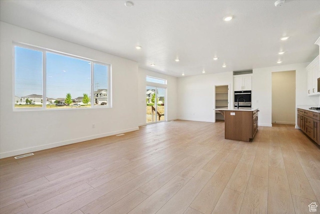 723 N Plainsman Dr Unit 109, Spanish Fork, UT 84660 - unfurnished living room with light wood-style floors and recessed lighting