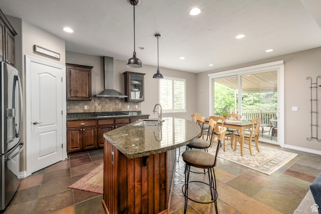10453 N Canterbury Pl, Highland, UT 84003 - kitchen featuring wall chimney range hood, stainless steel fridge, stone tile floors, decorative backsplash, and recessed lighting