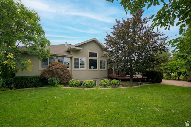 10453 N Canterbury Pl, Highland, UT 84003 - view of front of home featuring stucco siding, a wooden deck, and a front lawn